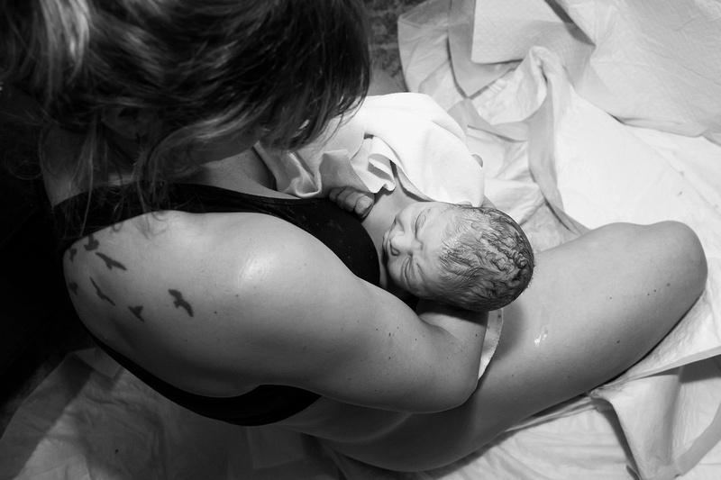 Mother holding newborn baby after a home birth 